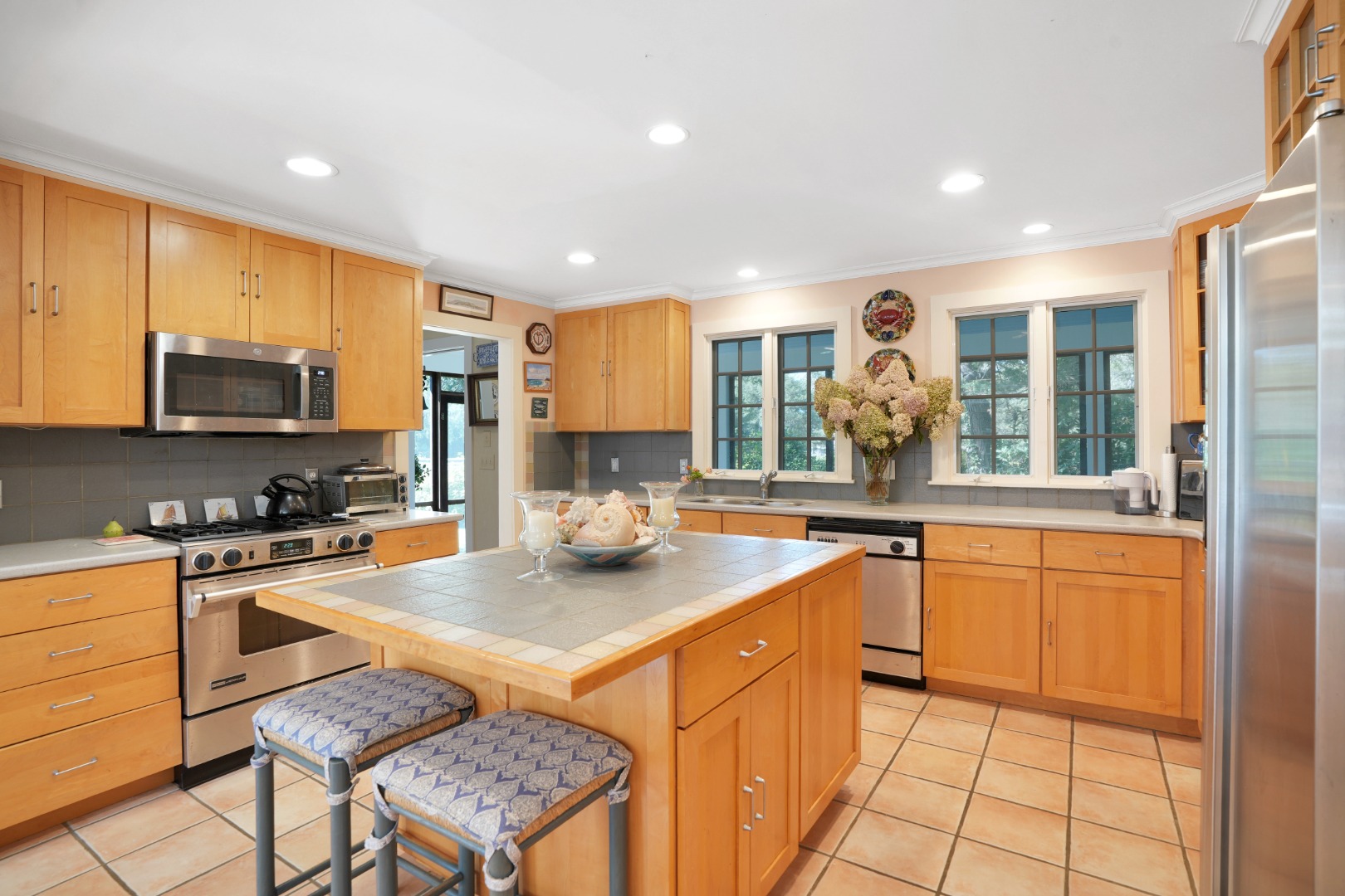 19 Kitts Field Circle Edgartown, MA 02539 - Photo 15 of 69 a kitchen with stainless steel appliances granite countertop a stove top oven a sink a dining table and chairs