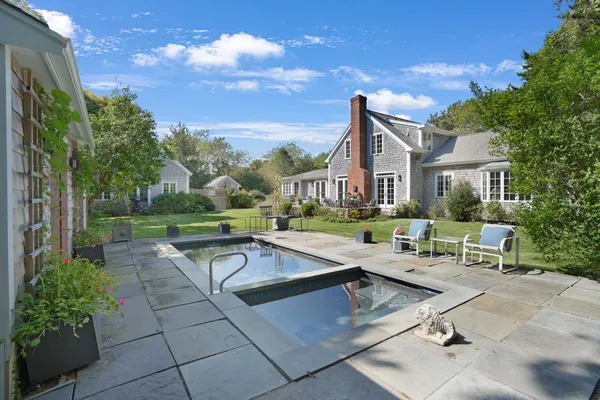 a view of a house with a backyard