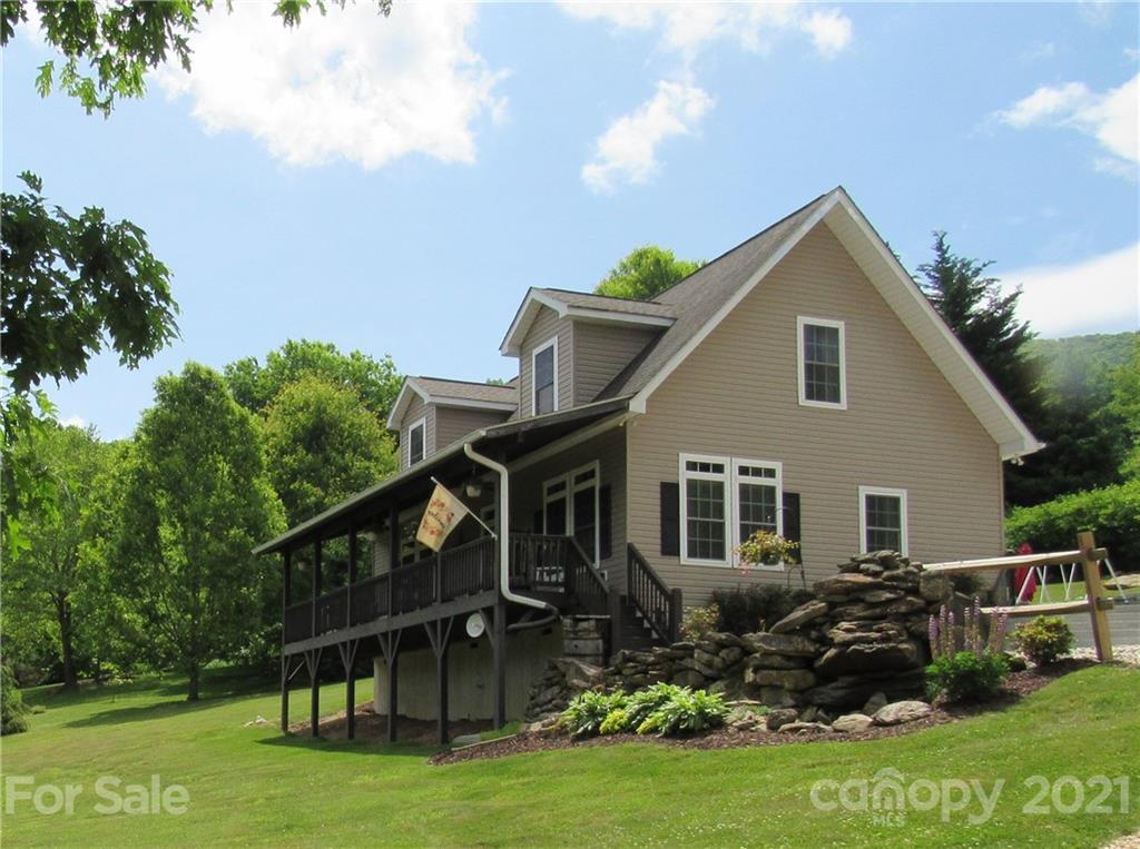 66 High Acres Road Waynesville, NC 28786 - Photo 1 of 41 a front view of house with yard and green space