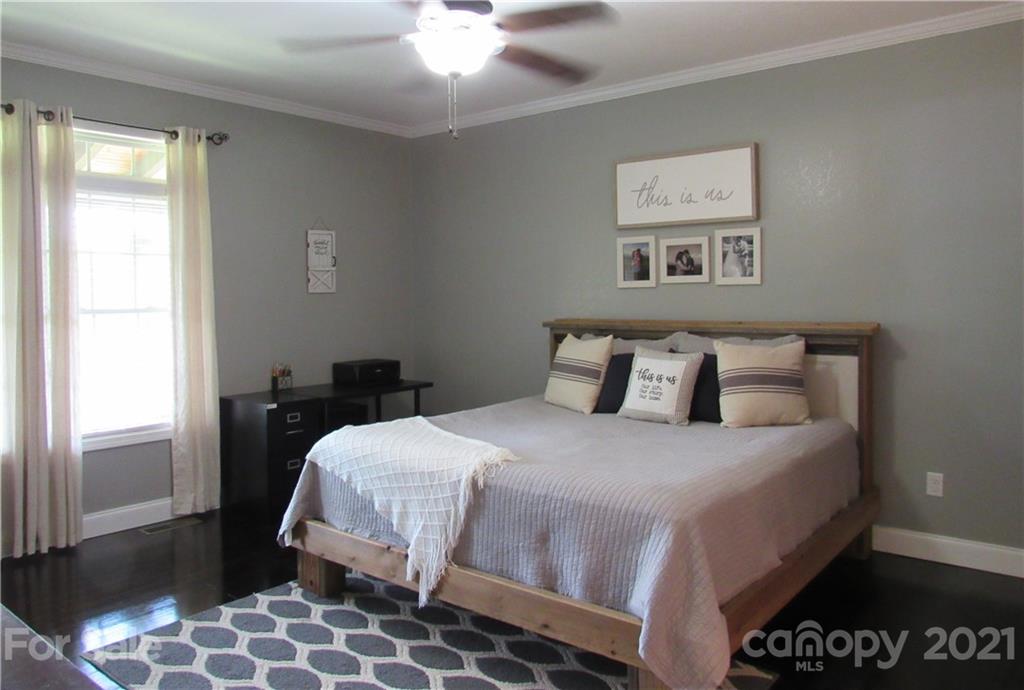 66 High Acres Road Waynesville, NC 28786 - Photo 13 of 41 a bedroom with a bed and a lamp on dresser