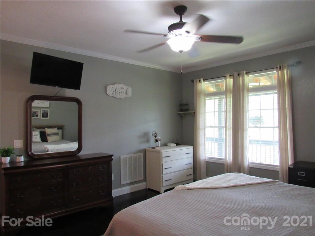 66 High Acres Road Waynesville, NC 28786 - Photo 14 of 41 a bedroom with a bed and a television