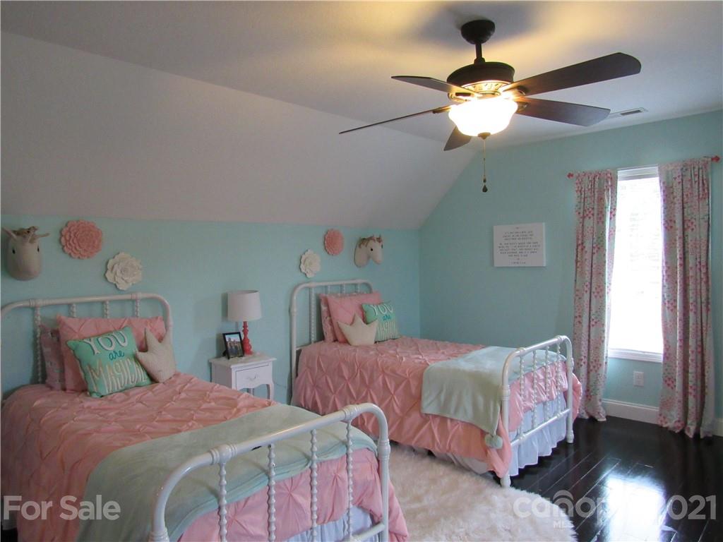 66 High Acres Road Waynesville, NC 28786 - Photo 19 of 41 a bedroom with a bed and a chandelier
