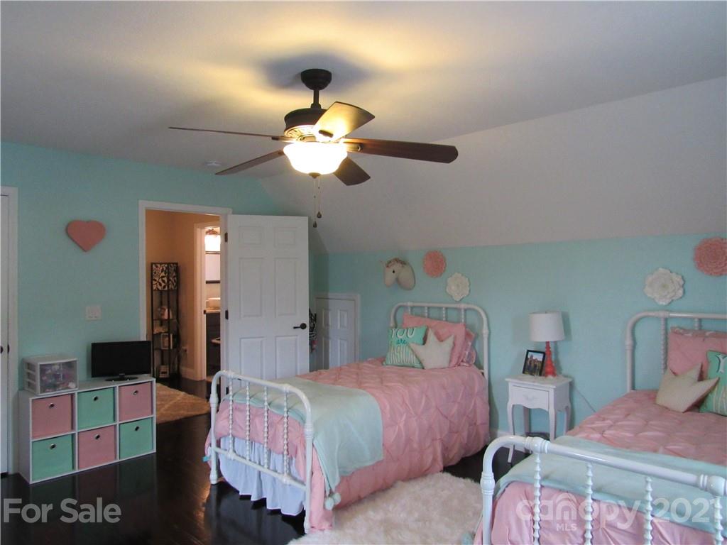 66 High Acres Road Waynesville, NC 28786 - Photo 21 of 41 a bedroom with a bed and a chandelier