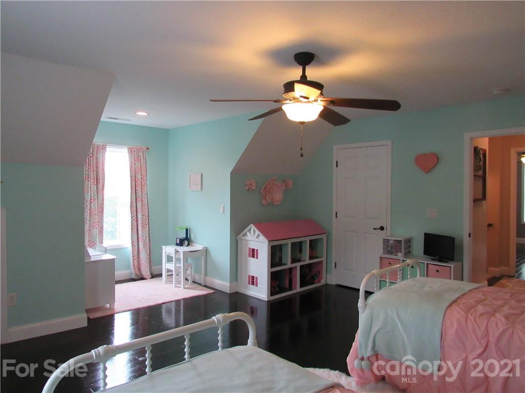 66 High Acres Road Waynesville, NC 28786 - Photo 22 of 41 a very nice looking bedroom with a bed and a chandelier