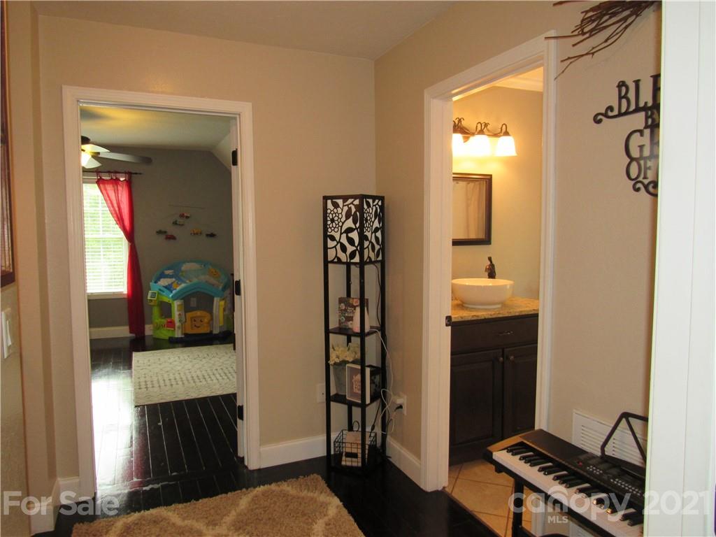66 High Acres Road Waynesville, NC 28786 - Photo 23 of 41 a view of a bedroom with wooden floor and windows