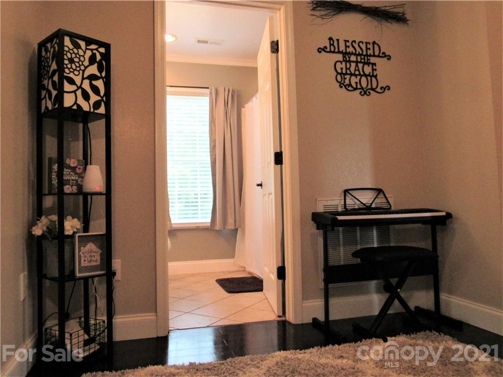 66 High Acres Road Waynesville, NC 28786 - Photo 25 of 41 a living room with furniture and a book shelf