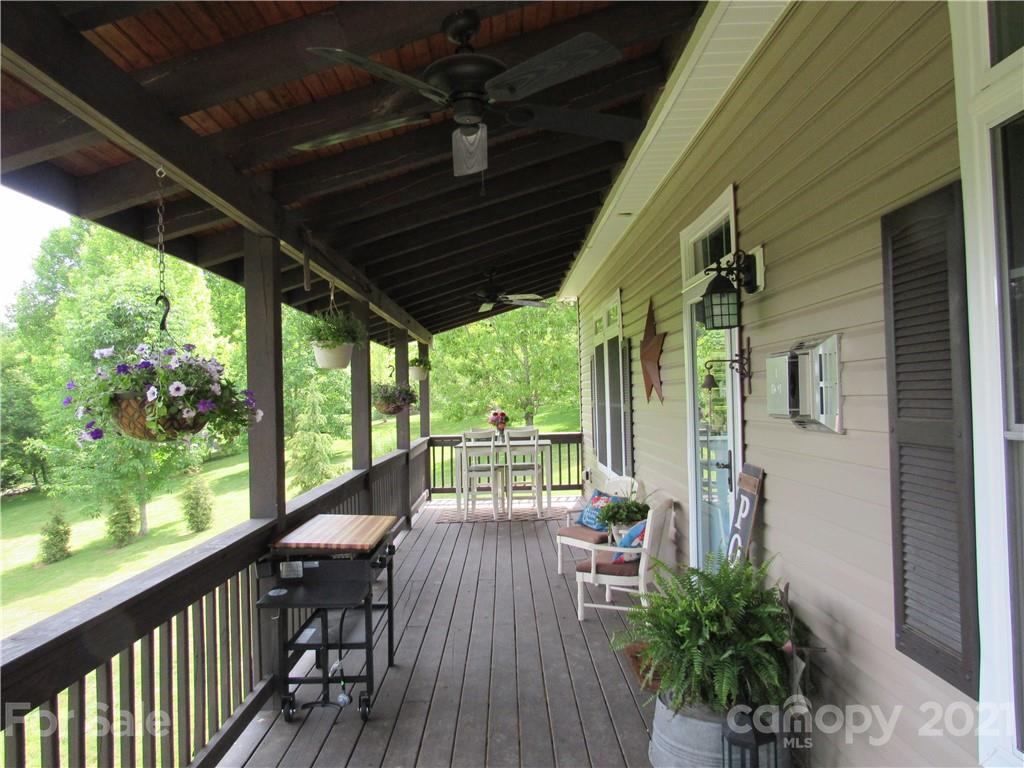 66 High Acres Road Waynesville, NC 28786 - Photo 29 of 41 a view of a porch with furniture and garden