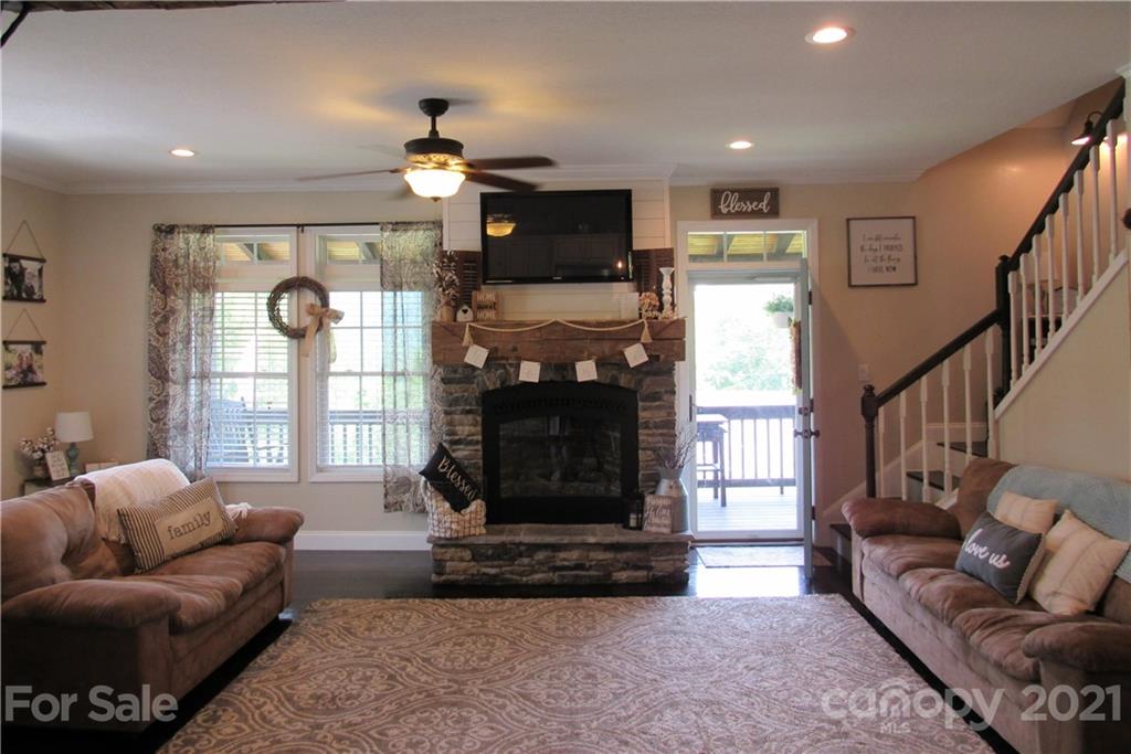 66 High Acres Road Waynesville, NC 28786 - Photo 4 of 41 a living room with furniture a flat screen tv and a fireplace