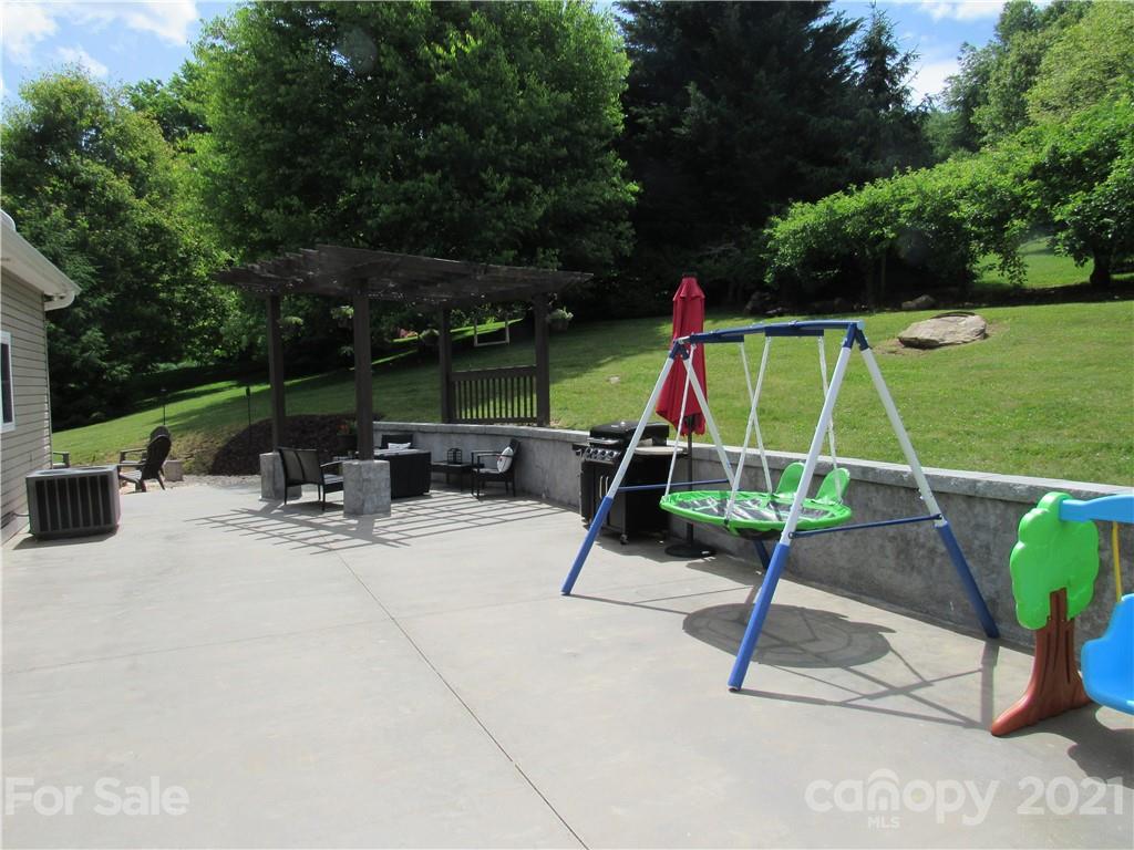 66 High Acres Road Waynesville, NC 28786 - Photo 32 of 41 a view of a park with swings