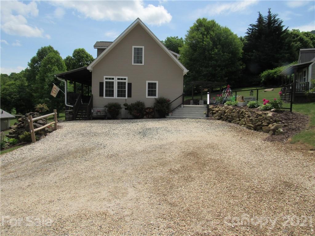 66 High Acres Road Waynesville, NC 28786 - Photo 41 of 41 a view of a house with backyard and sitting area