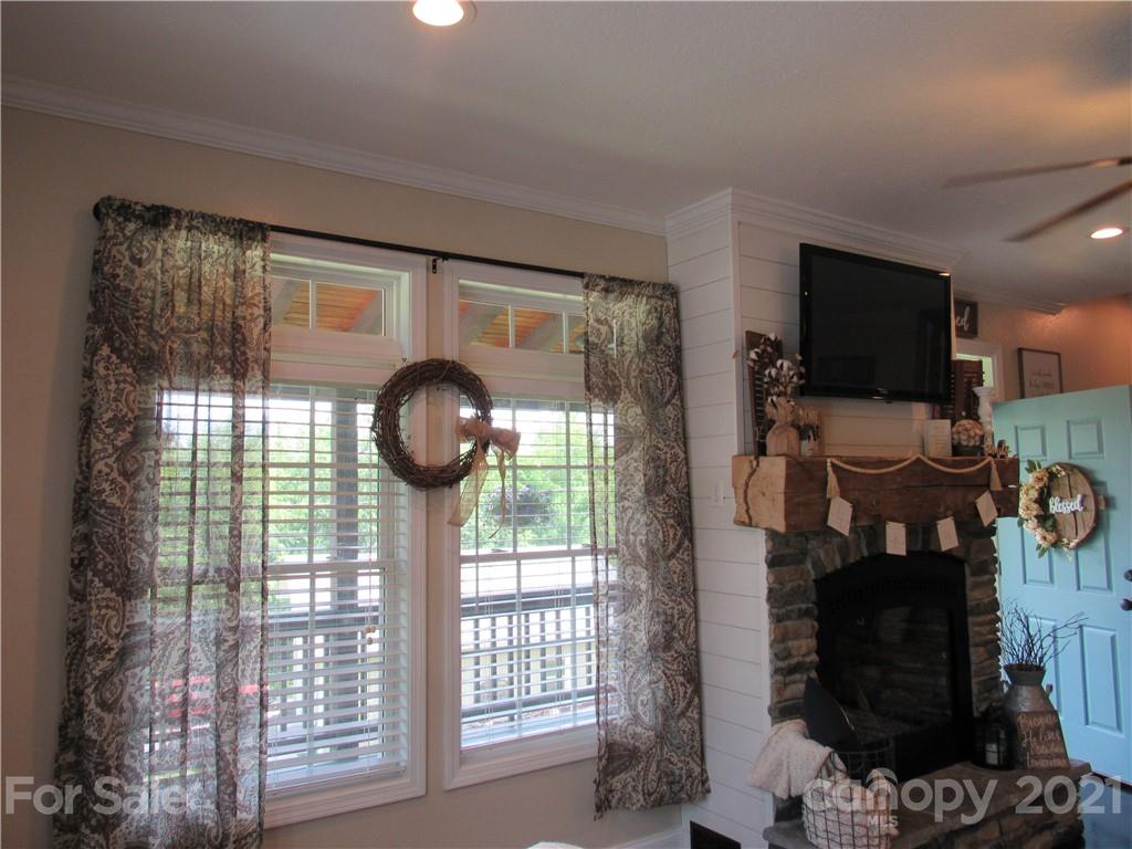 66 High Acres Road Waynesville, NC 28786 - Photo 6 of 41 a view of a livingroom with furniture and a fireplace