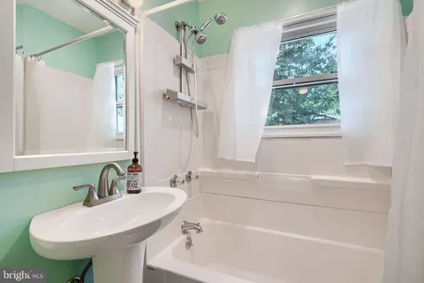 a bathroom with a sink a toilet and a bathtub