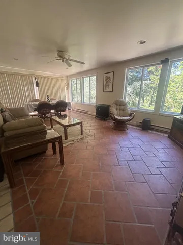 a living room with furniture and a floor to ceiling window