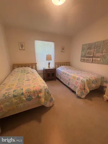 a bedroom with two beds and a window