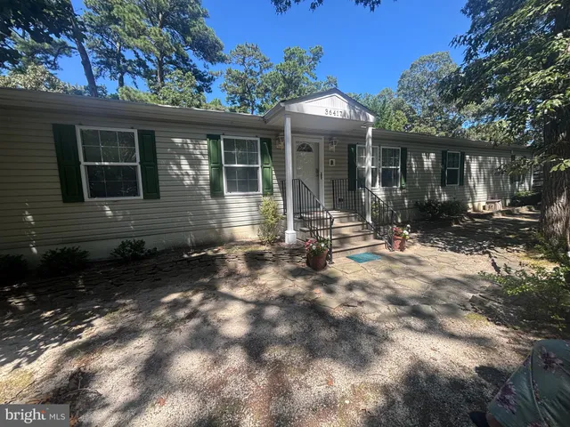 a front view of a house with yard outdoor seating and barbeque oven