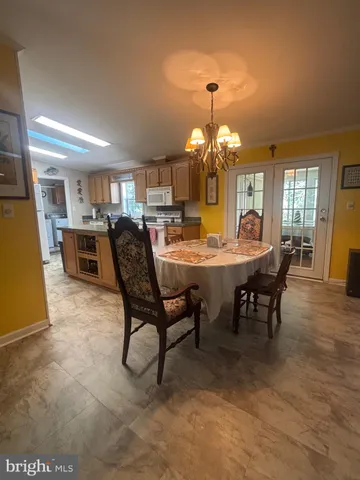 a view of a dining room with furniture and chandelier