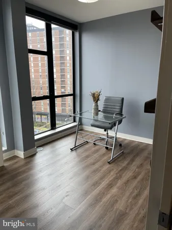a view of a workspace with furniture and a window