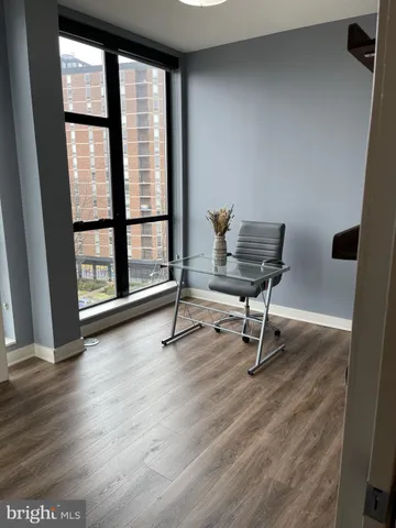 a view of a workspace with furniture and a window