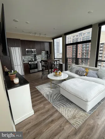 a living room with furniture and large windows