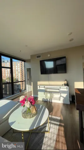 a living room with furniture and flat screen tv