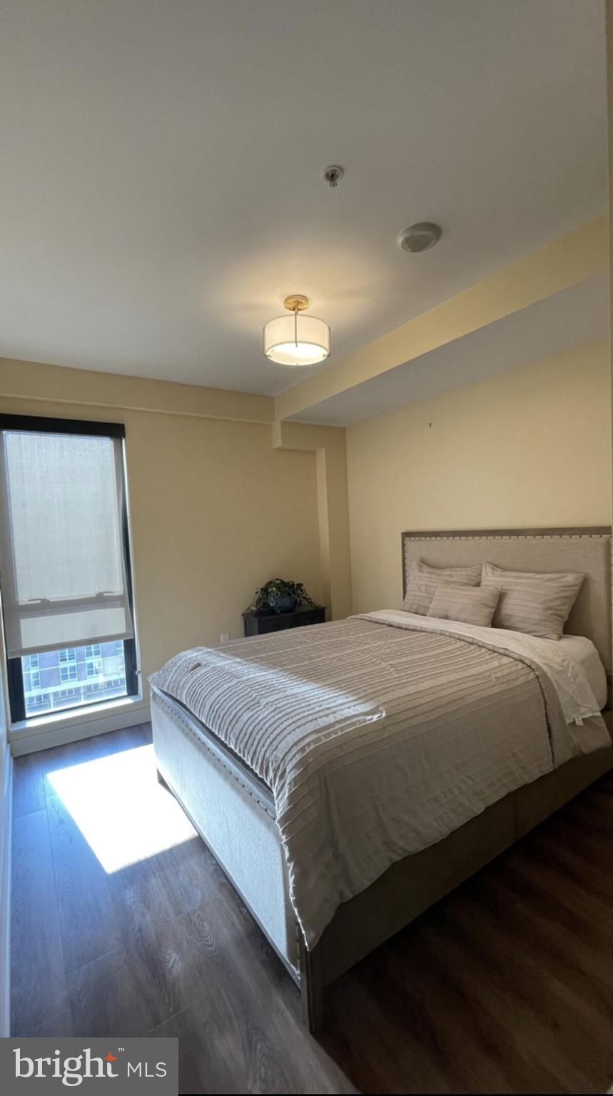 1320 Fenwick Lane, Unit 802 Silver Spring, MD 20910 - Photo 6 of 23 a bedroom with a bed and a night stand