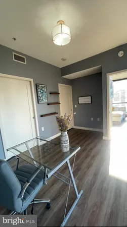 a living room with dining room and wooden floor