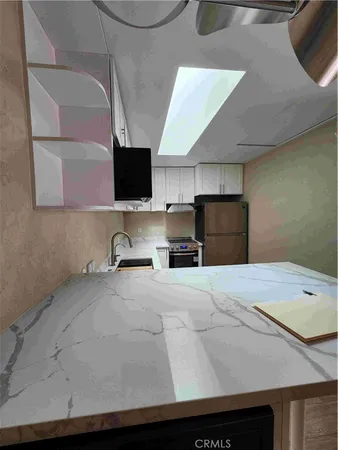 a kitchen with a sink and a refrigerator