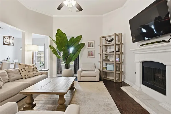 a living room with furniture a flat screen tv and a fireplace