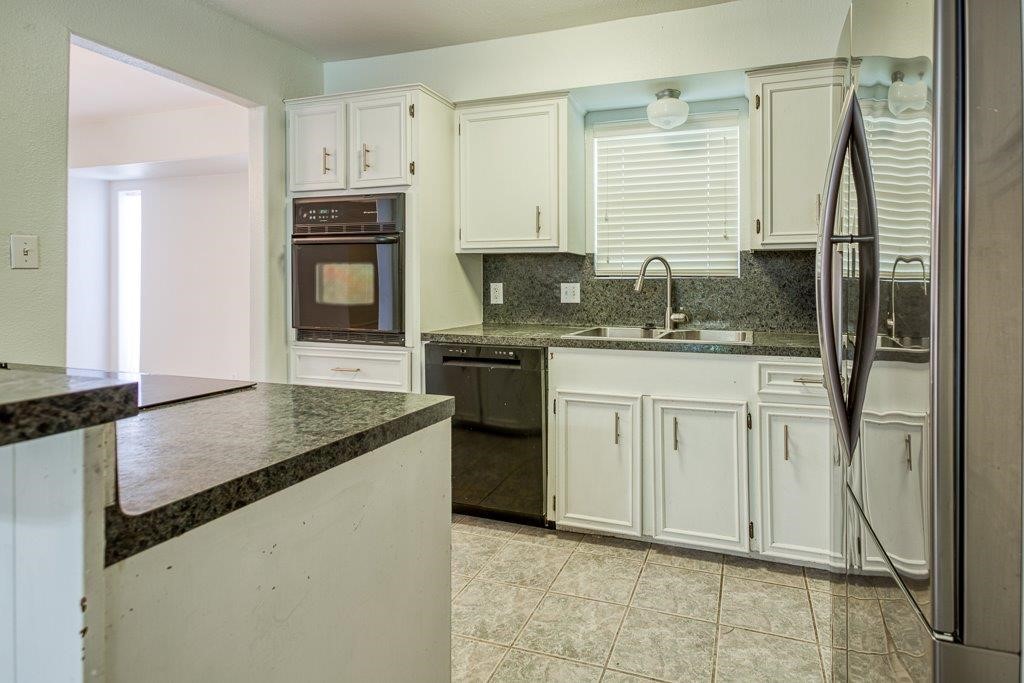 113 Seco Drive Portland, TX 78374 - Photo 13 of 37 a kitchen with stainless steel appliances granite countertop a sink stove and refrigerator