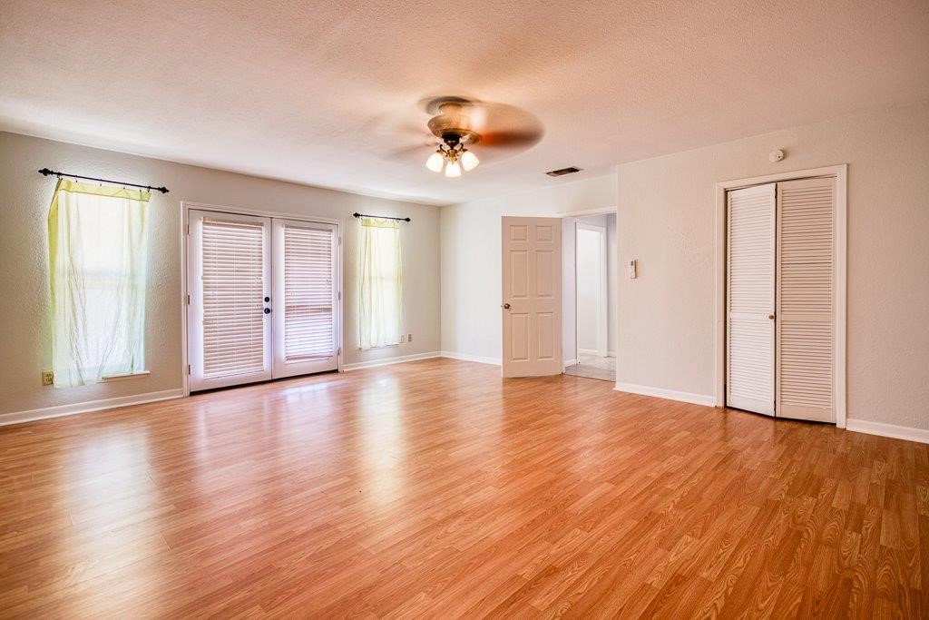113 Seco Drive Portland, TX 78374 - Photo 21 of 37 a view of an empty room with wooden floor and a window