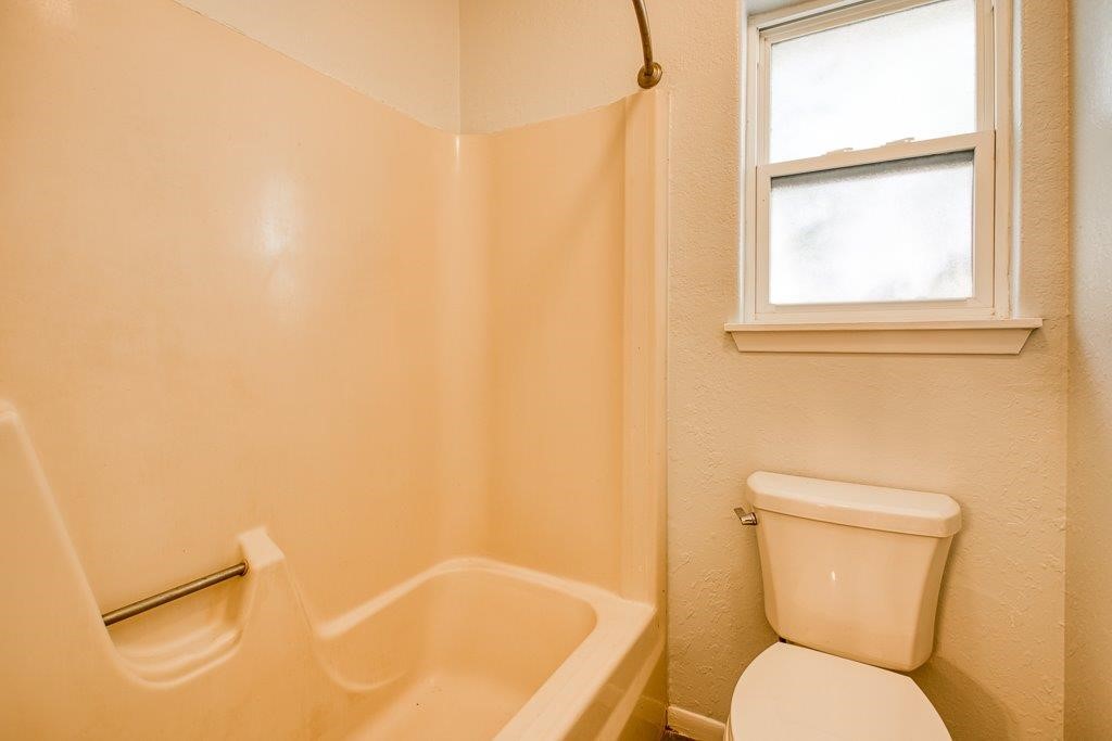 113 Seco Drive Portland, TX 78374 - Photo 26 of 37 a white toilet sitting next to a bath tub