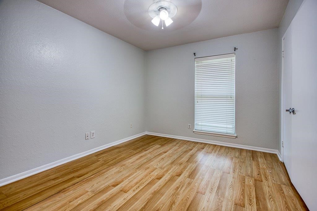 113 Seco Drive Portland, TX 78374 - Photo 27 of 37 an empty room with wooden floor and windows