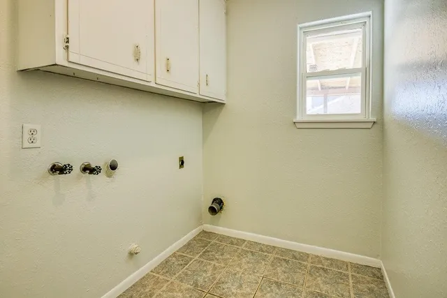a view of a backyard with table and chairs under an umbrella with a small yard