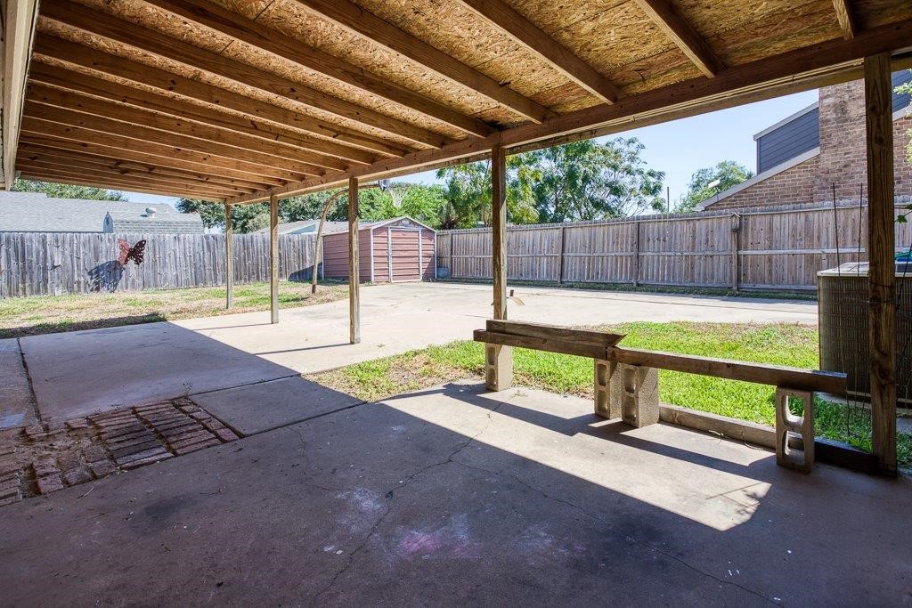 113 Seco Drive Portland, TX 78374 - Photo 34 of 37 a view of a backyard with table and chairs under an umbrella with a small yard