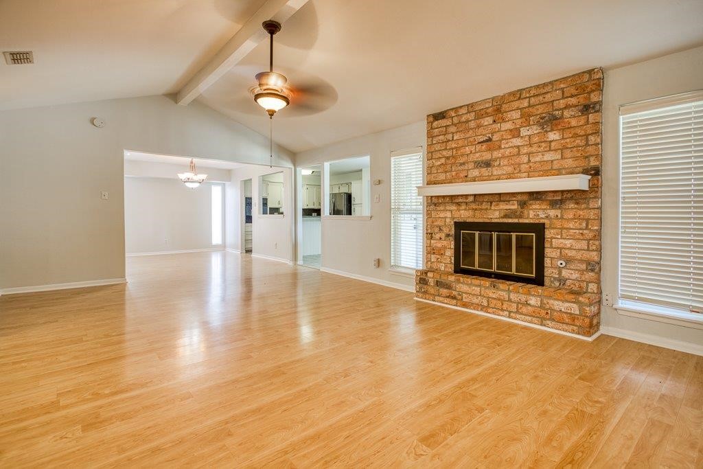 113 Seco Drive Portland, TX 78374 - Photo 4 of 37 a view of a livingroom with wooden floor a fireplace and window