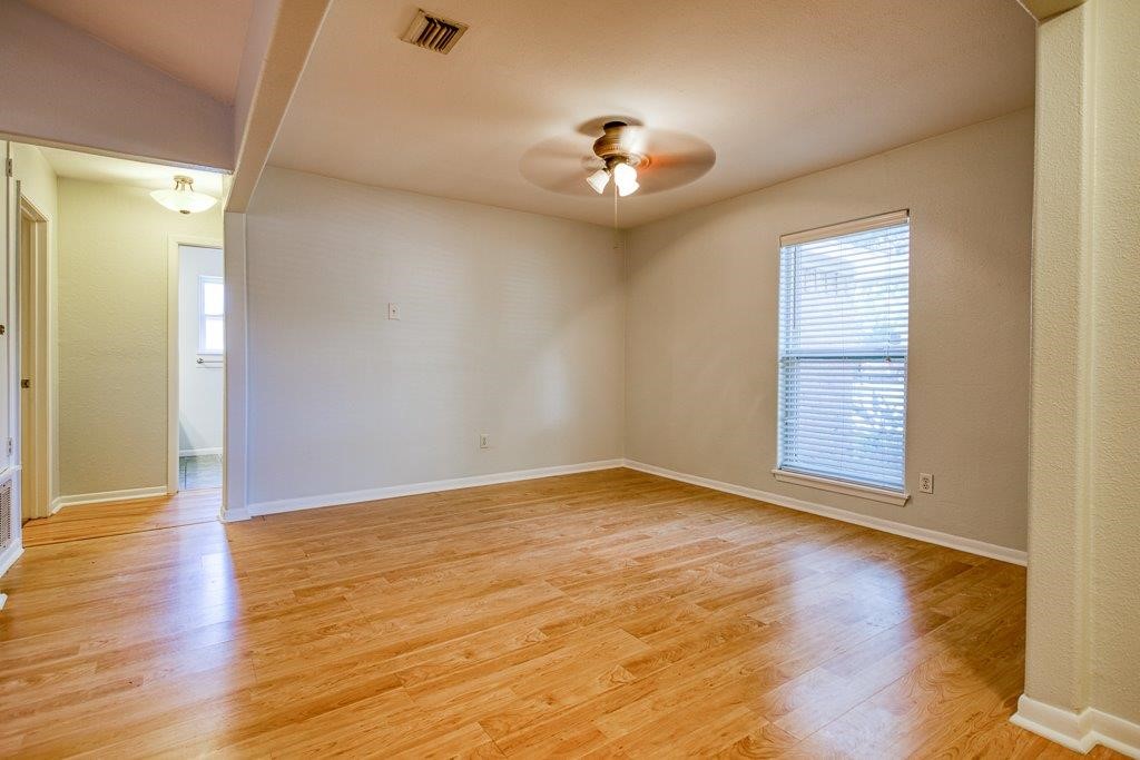 113 Seco Drive Portland, TX 78374 - Photo 7 of 37 a view of an empty room with wooden floor and a window