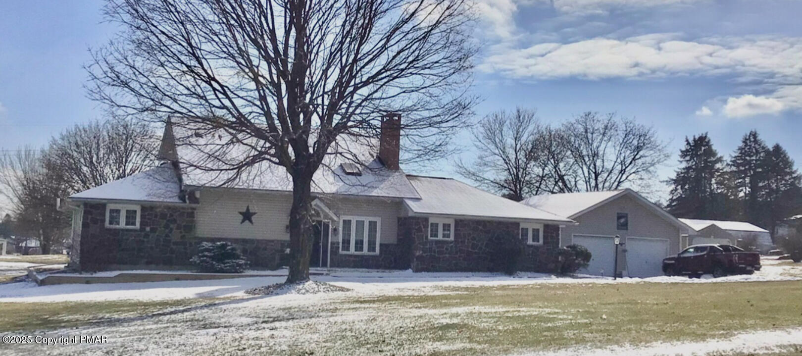 a front view of house with yard and trees