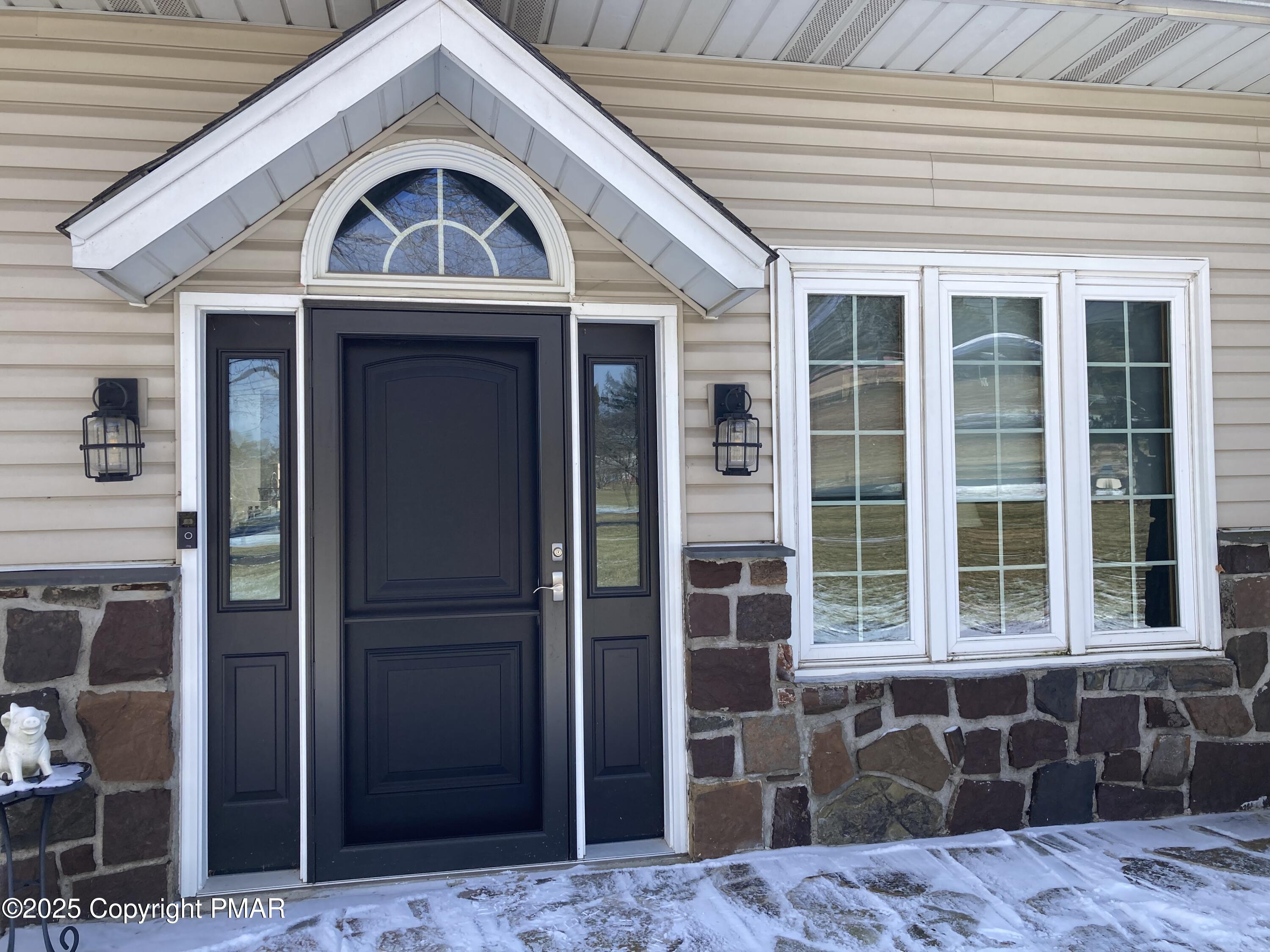 534 Sandt Road Pen Argyl, PA 18072 - Photo 13 of 77 a front view of a house with a glass door