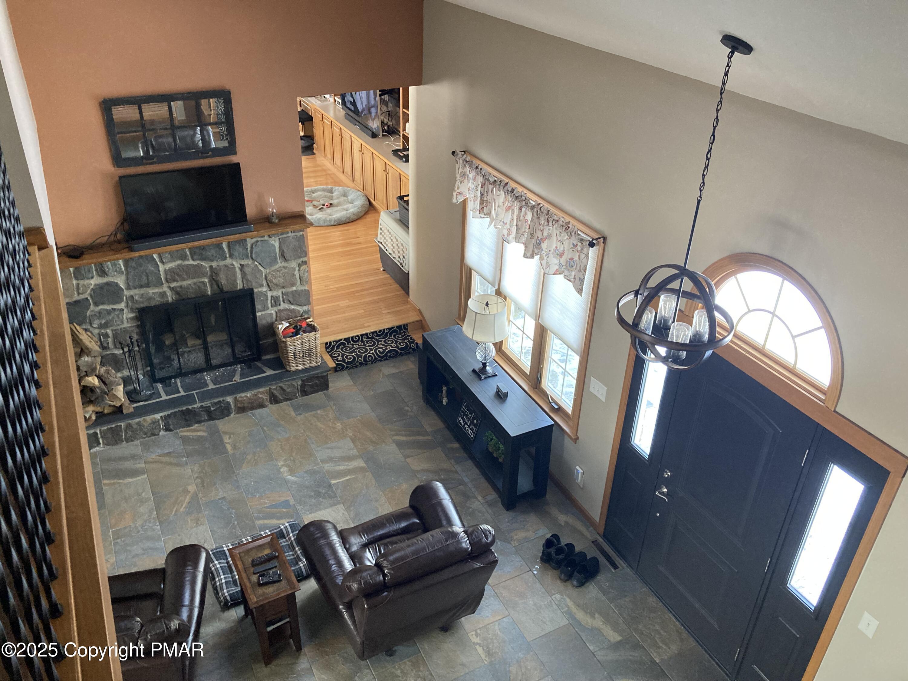 534 Sandt Road Pen Argyl, PA 18072 - Photo 16 of 77 a living room with furniture a fireplace and a flat screen tv