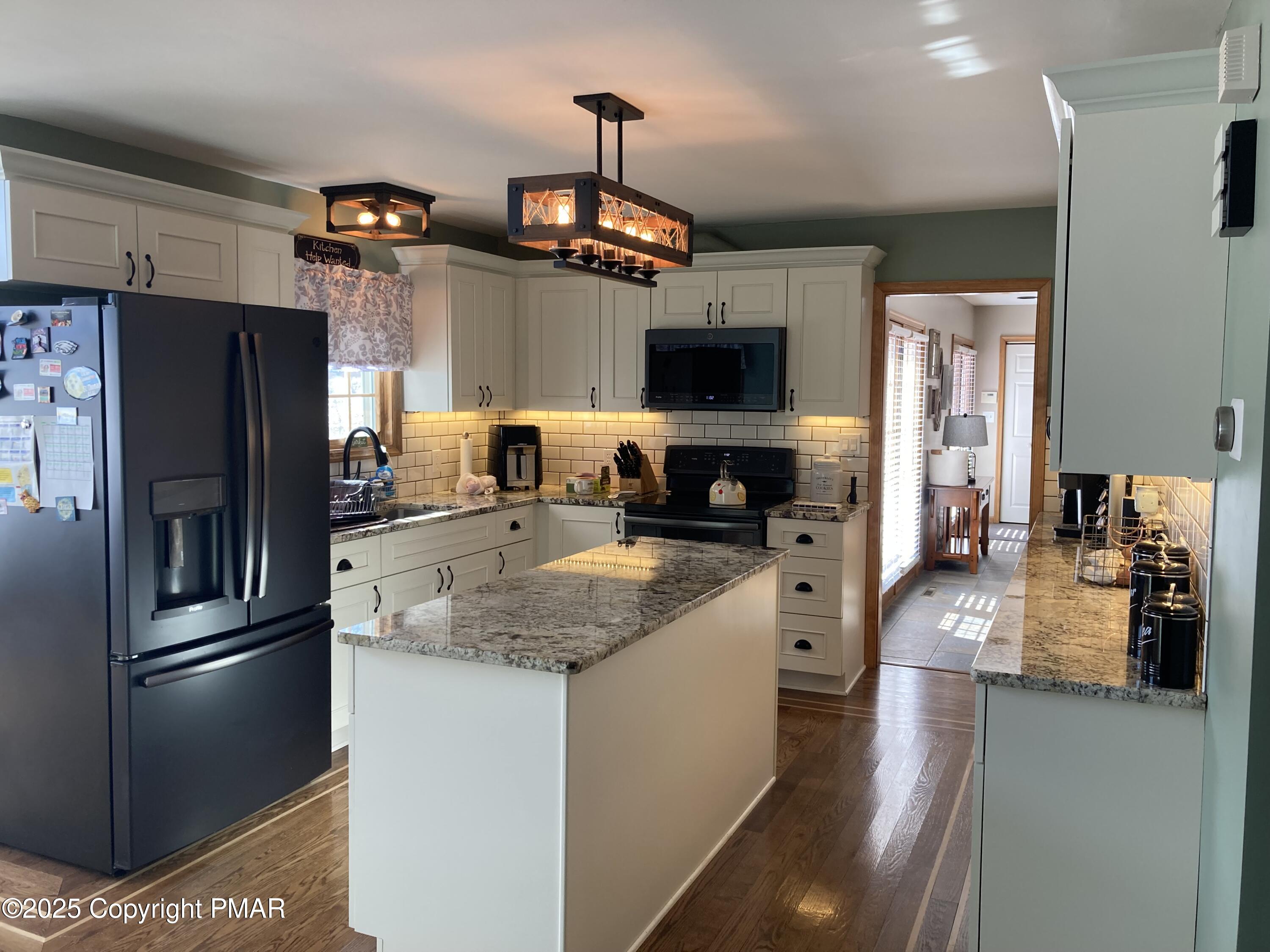 534 Sandt Road Pen Argyl, PA 18072 - Photo 21 of 77 a kitchen with stainless steel appliances granite countertop a refrigerator a stove a sink a oven with a dining table and chairs