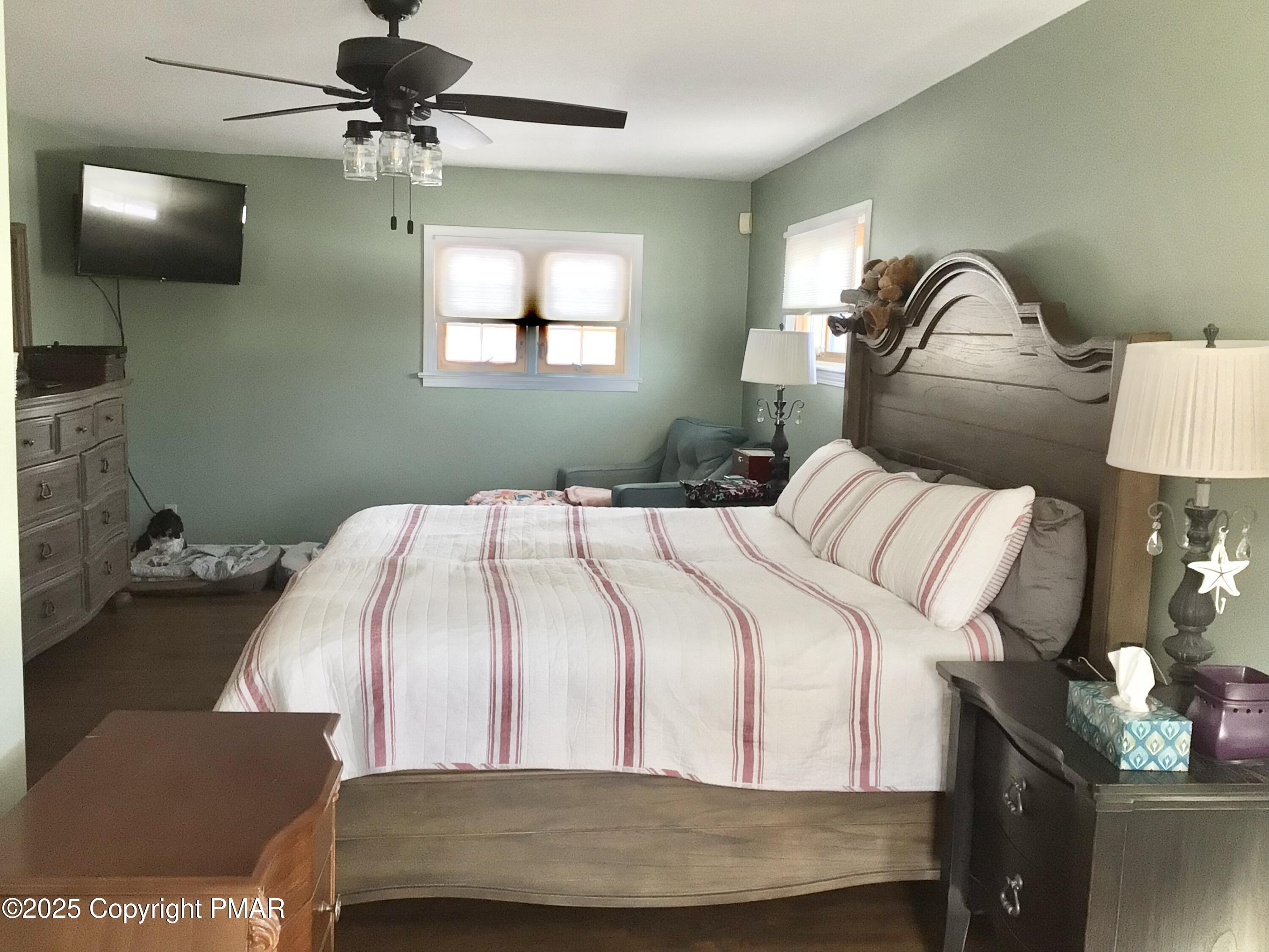 534 Sandt Road Pen Argyl, PA 18072 - Photo 42 of 77 a bedroom with a bed and a chandelier