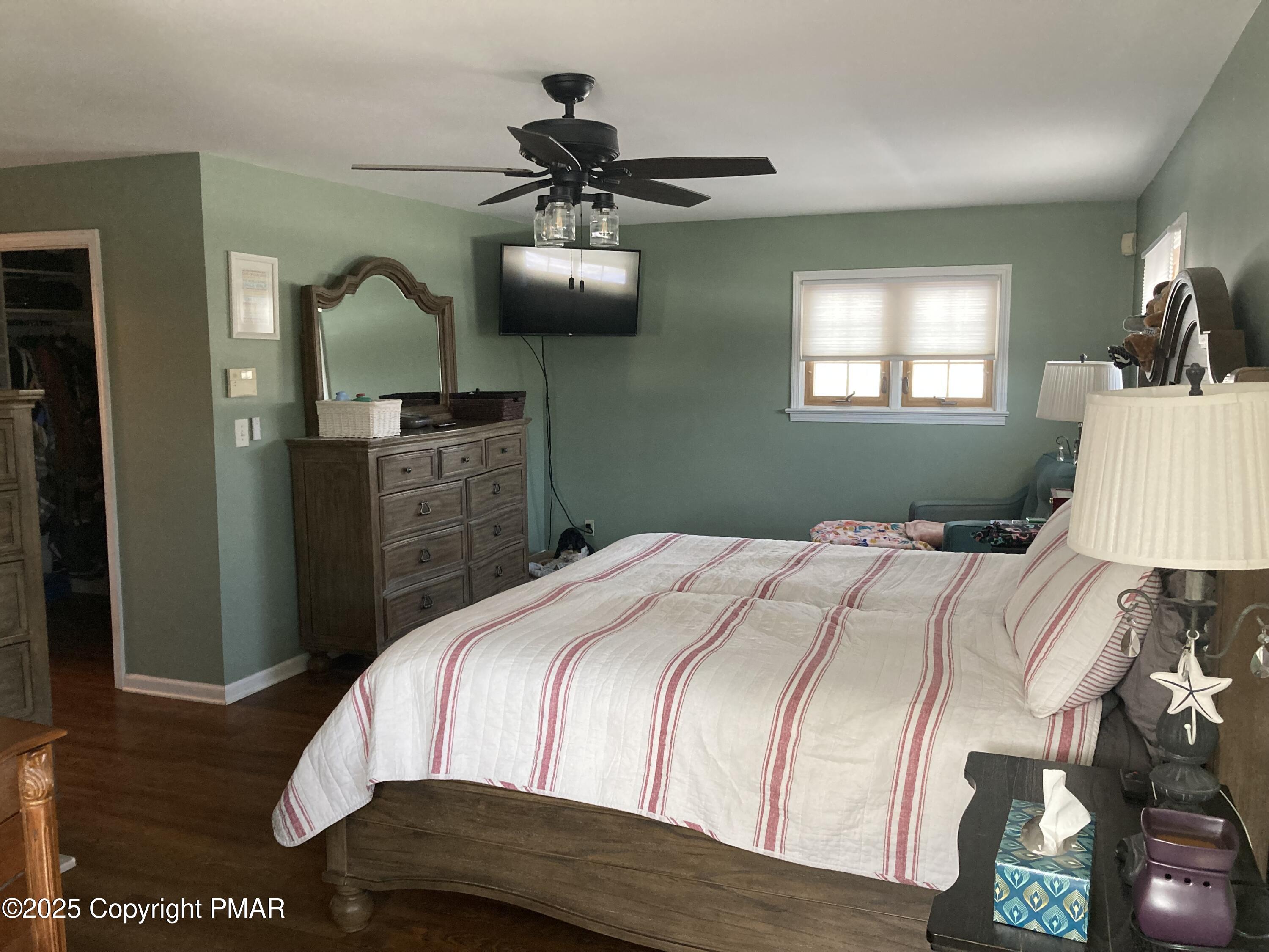 534 Sandt Road Pen Argyl, PA 18072 - Photo 45 of 77 a bedroom with a bed and a chandelier