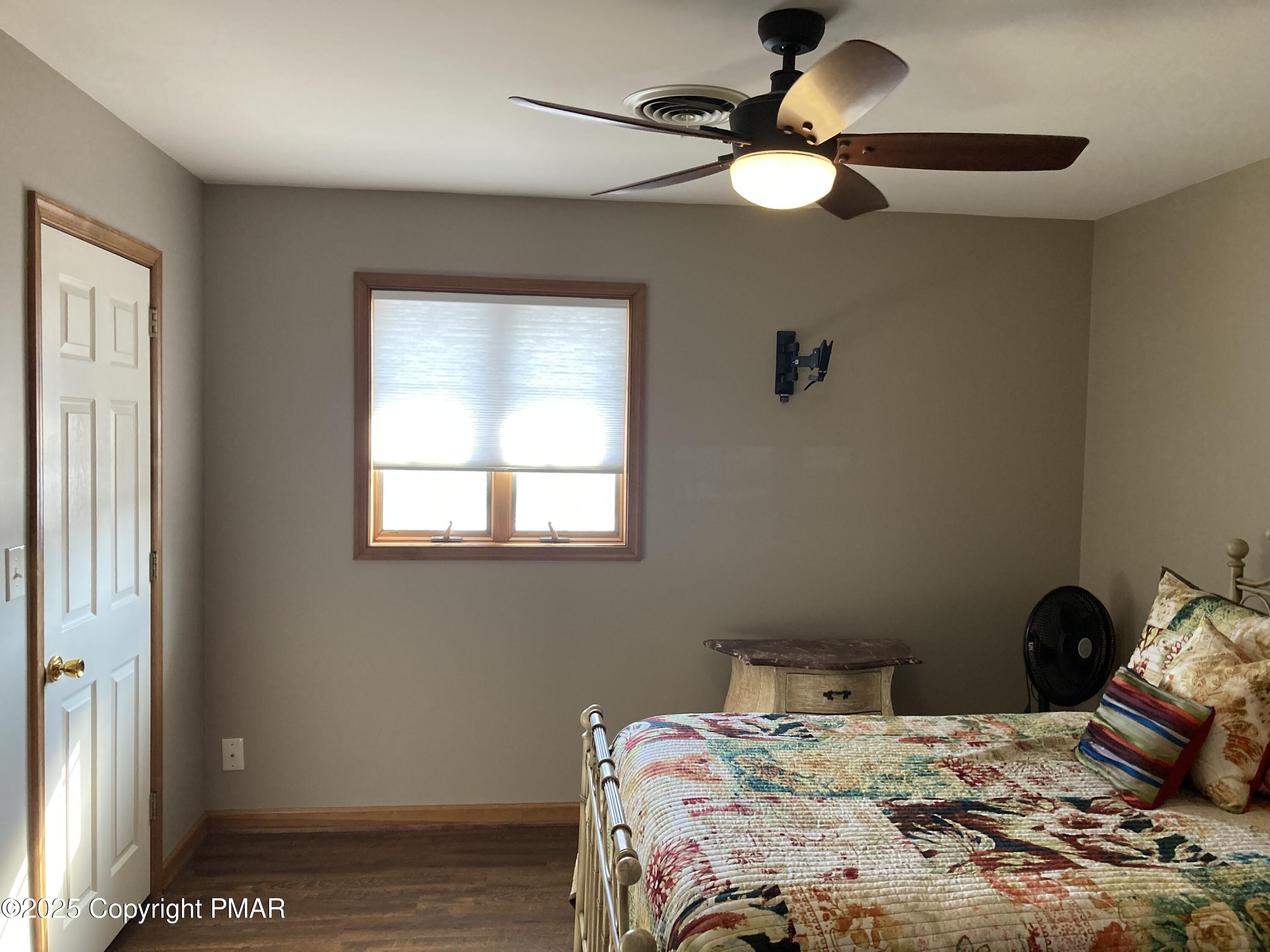534 Sandt Road Pen Argyl, PA 18072 - Photo 56 of 77 a bedroom with a bed and a chandelier