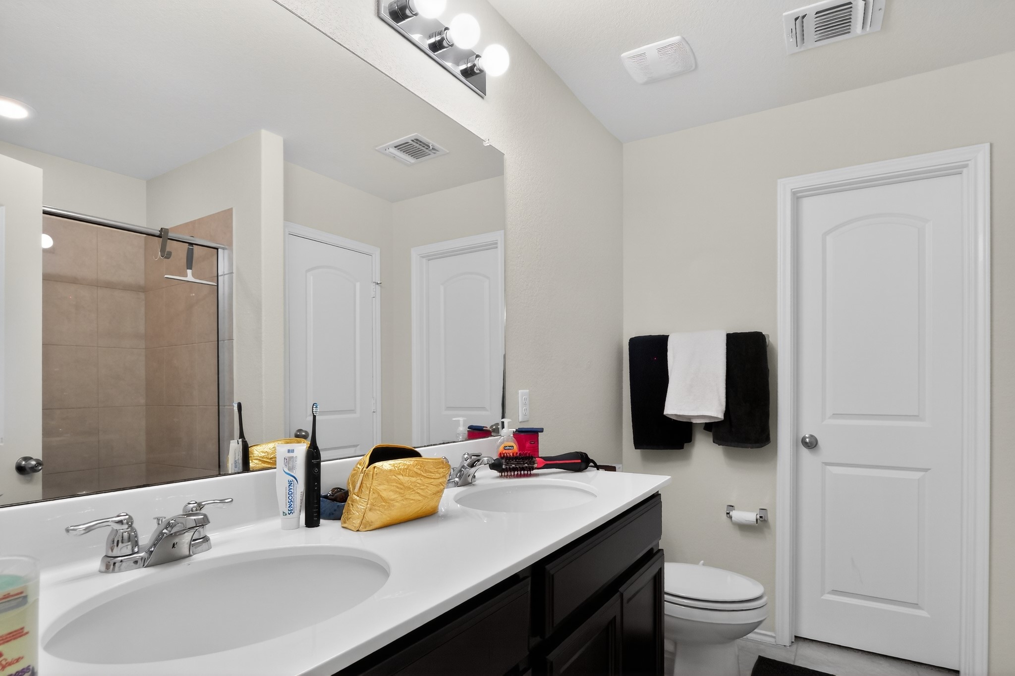 521 Staton Street Georgetown, TX 78626 - Photo 21 of 39 a bathroom with a granite countertop sink toilet and mirror