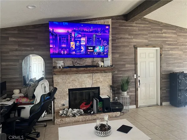 a living room with furniture a fireplace and a piano