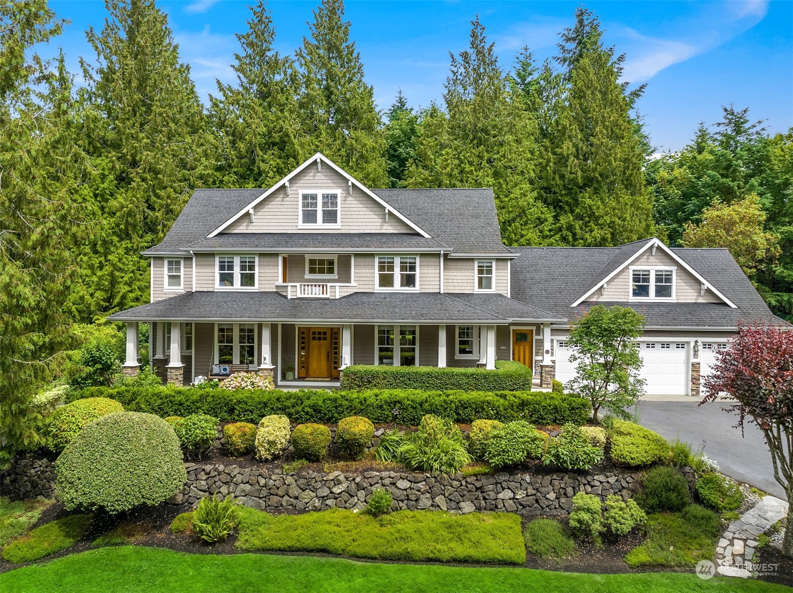 6428 Haley Loop Road Northeast Bainbridge Island, WA 98110 - Photo 1 of 40 a front view of a house with a yard