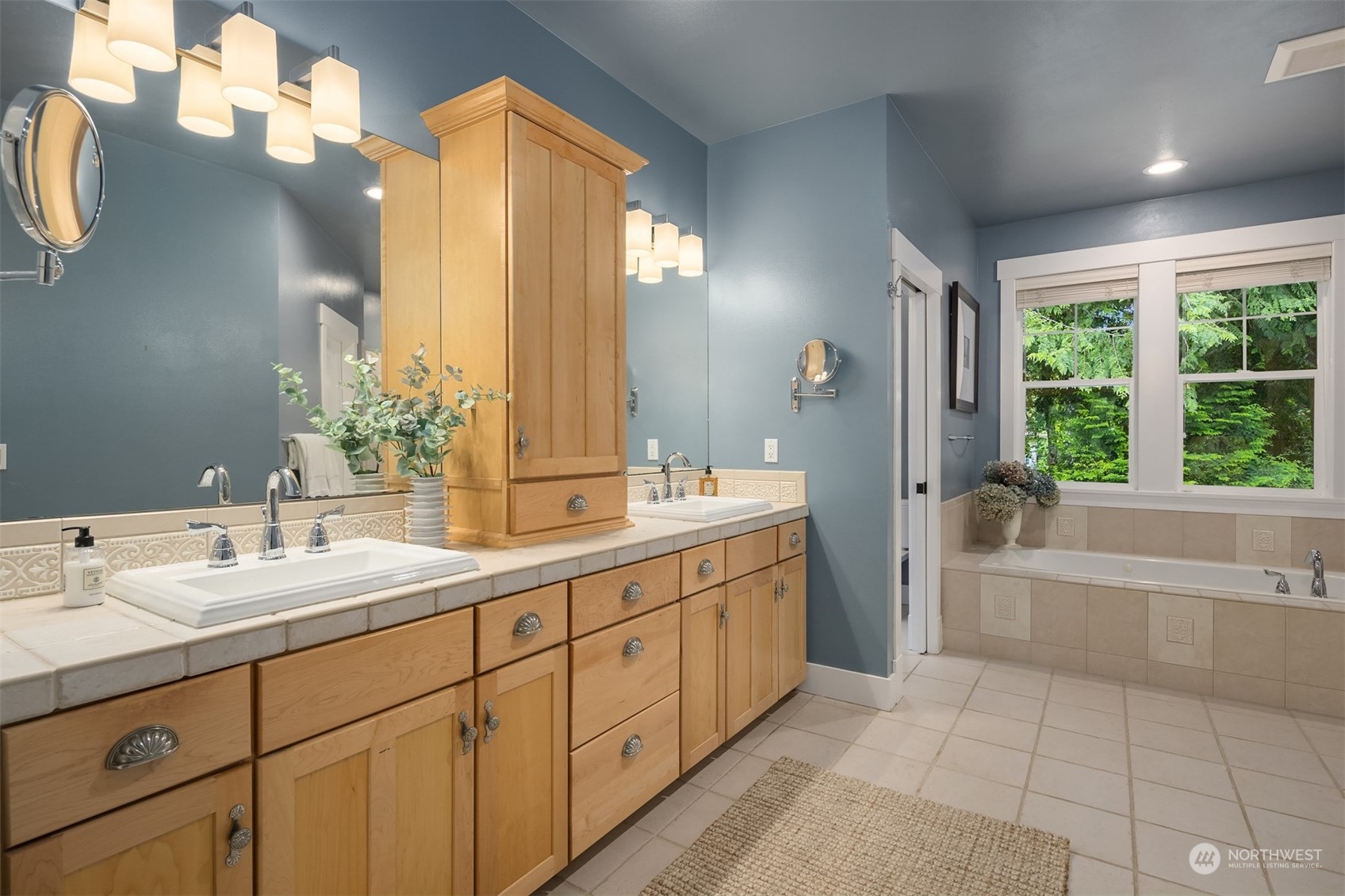6428 Haley Loop Road Northeast Bainbridge Island, WA 98110 - Photo 14 of 40 a bathroom with a double vanity sink mirror and a bathtub