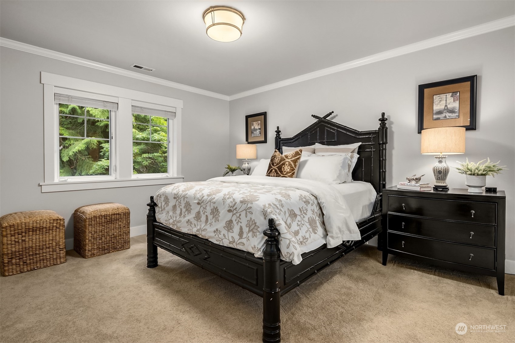 6428 Haley Loop Road Northeast Bainbridge Island, WA 98110 - Photo 25 of 40 a large bed sitting in a bedroom next to a window with lamp and dresser