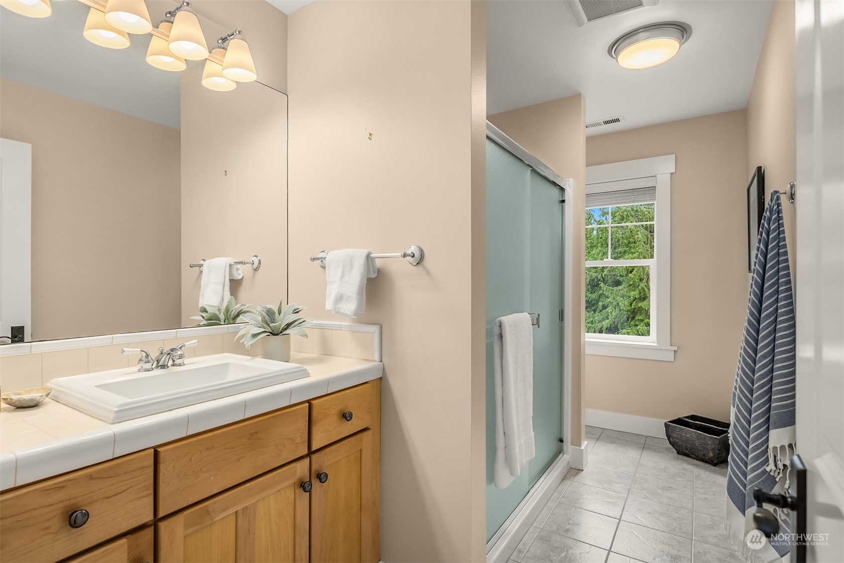 6428 Haley Loop Road Northeast Bainbridge Island, WA 98110 - Photo 26 of 40 a bathroom with a sink double vanity and a mirror