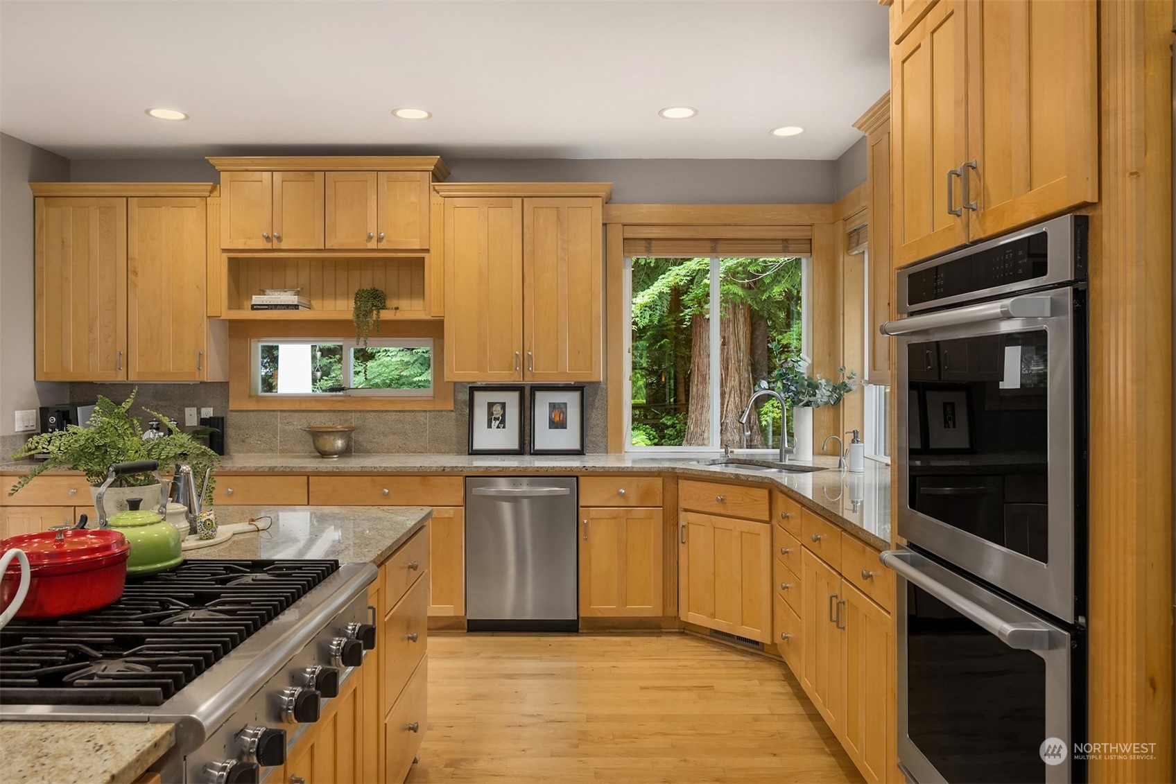 6428 Haley Loop Road Northeast Bainbridge Island, WA 98110 - Photo 6 of 40 a kitchen with stainless steel appliances granite countertop a stove a sink and a refrigerator